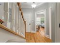 Hallway with hardwood floors leading to front door and bedroom at 626 Windermere Blvd # 4D, Charleston, SC 29407