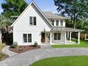 Charming two-story white home with a well-manicured lawn and inviting curb appeal at 755 Adluh St, Mount Pleasant, SC 29464