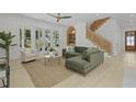 Bright living room with wood floors, stylish furniture, and a staircase with woven accents at 755 Adluh St, Mount Pleasant, SC 29464