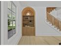 Stylish built-in shelving and woven-accent staircase add character to this bright living space at 755 Adluh St, Mount Pleasant, SC 29464