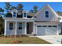 Attractive, light-pink, single-story home boasting a two-car garage, and inviting front porch at 761 Maynard Ln, Summerville, SC 29486