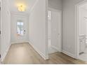 Bright hallway with wood flooring and a view to the front door, and a bathroom at 761 Maynard Ln, Summerville, SC 29486