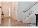 Light-filled entryway with wood floors leading to the staircase and front door at 7850 Wilderness Trl # 6A, North Charleston, SC 29418