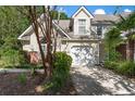 Charming home featuring a two-car garage, well-maintained landscaping, and mature trees at 8651 Grassy Oaks Trl, North Charleston, SC 29420