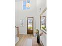Bright foyer with wood floors, a staircase, a transom window, and a decorative mirror at 8654 Windsor Hill Blvd, North Charleston, SC 29420