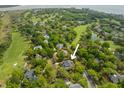 Serene aerial view of the property nestled amongst mature trees, close to golf course and waterways at 1 Bay Ct, Isle of Palms, SC 29451