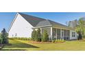 A sprawling backyard offers a screened-in porch, lush landscaping, and plenty of space for outdoor living at 1003 Sagegrass St, Summerville, SC 29485