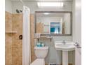 Bright bathroom featuring a tiled shower, toilet and mirrored vanity with sink at 1004 Ocean Blvd # 108, Isle of Palms, SC 29451
