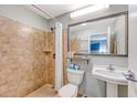 Bright bathroom featuring a tiled shower, toilet and mirrored vanity with sink at 1004 Ocean Blvd # 108, Isle of Palms, SC 29451