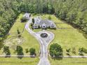 A sprawling estate showcasing lush landscaping, equestrian features, and a private, secluded setting at 1019 Spiers Cir, Bonneau, SC 29431