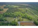 Panoramic aerial view showcasing a home, open land, and dense woodland with trails and nature at 1050 Mt Zion Rd, Saint George, SC 29477