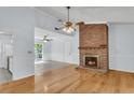 Spacious living room boasts an open layout, hardwood floors, and a glimpse into the kitchen area at 106 Chaff Ct, Summerville, SC 29485