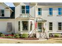 A pristine two-story home with a bay window, complemented by lush landscaping and traditional architectural details at 1081 Groves Manor Ct, Mount Pleasant, SC 29464