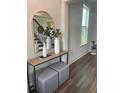 Inviting foyer with wood floors, a decorative mirror, console table, and view of the staircase at 109 Crosscut Ln, Summerville, SC 29486