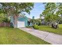 Charming blue-green home with a well-kept lawn and a garage and nice landscaping at 1135 Shoreham Rd, Charleston, SC 29412