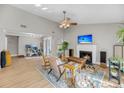 Spacious living room with a fireplace, comfortable seating, and an adjacent office space, with wood floors at 1135 Shoreham Rd, Charleston, SC 29412