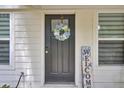 Close up of front door and wreath next to 'welcome' sign and big windows at 115 Ridge Rd, Summerville, SC 29485