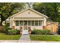 Charming single-story home with manicured lawn and quaint awning and adjacent parking at 116 Magnolia Ave, Charleston, SC 29403