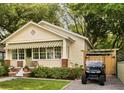 Charming single-story home with manicured lawn and quaint awning and adjacent parking with golf cart at 116 Magnolia Ave, Charleston, SC 29403