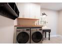 Well-organized laundry room featuring modern washer and dryer, sink and storage at 117 Lucia St, Charleston, SC 29492