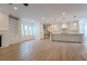 Spacious living room features hardwood floors, fireplace and open floor plan with kitchen at 117 Lucia St, Charleston, SC 29492