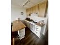 Efficient kitchen with white cabinetry, breakfast bar, and stainless steel appliances at 1300 Ocean Blvd # 308, Isle of Palms, SC 29451