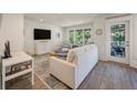 Bright living room featuring modern furnishings, wood floors, and a sliding glass door to an outdoor deck at 1365 Dunlin Court, Share D, Kiawah Island, SC 29455