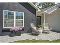 Home exterior featuring a cozy patio with chairs, brickwork, and a decorative wreath at 1366 W Point Dr, Mount Pleasant, SC 29466