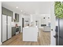 Modern kitchen with a large island, sleek cabinets, and stainless steel appliances at 1366 W Point Dr, Mount Pleasant, SC 29466