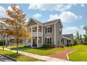 Charming two-story home featuring a welcoming front porch and manicured lawn in a peaceful neighborhood at 1417 Roustabout Way, Charleston, SC 29414