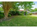 Charming single-story home framed by a lush green lawn and mature trees at 1707 Sharon Ave, Charleston, SC 29407
