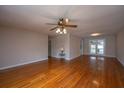 Bright and airy living room with hardwood floors, ceiling fan, and access to the outdoor patio at 1707 Sharon Ave, Charleston, SC 29407