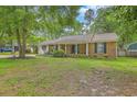 Charming single-story brick home with a covered front porch and lush green lawn at 204 Pointer Dr, Summerville, SC 29485