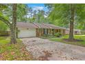 Well-maintained brick home featuring an attached garage and mature trees at 204 Pointer Dr, Summerville, SC 29485