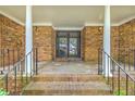 Inviting brick front porch featuring stately columns and a glass-paneled front door at 204 Pointer Dr, Summerville, SC 29485