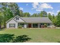 Charming single-story home with manicured lawn and front porch with red door at 209 Cheyenne Rd, Summerville, SC 29483