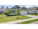 Charming single-story home featuring a well-maintained lawn and attached two-car garage at 212 Rubles Ln, Moncks Corner, SC 29461