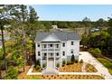 Charming two-story home with a welcoming front porch, well-manicured lawn, and mature trees at 2372 Darts Cove Way, Mount Pleasant, SC 29466