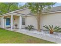 Charming home with manicured lawn, stone landscaping, and a cozy front porch at 2427 Stingray Blvd, North Charleston, SC 29406