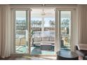 Relaxing screened-in patio with comfortable seating and a peaceful lake view at 247 Godwit Dr, Summerville, SC 29486