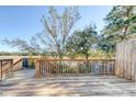 Wooden deck overlooking trees and water with railing offers serene outdoor living and relaxation at 27 Brockman Dr # 27-C, Charleston, SC 29412