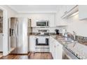 Well-lit kitchen with stainless steel appliances, granite countertops, and white cabinetry at 27 Brockman Dr # 27-C, Charleston, SC 29412