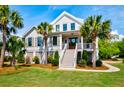 Charming two-story home with a prominent front-facing staircase and meticulously maintained landscaping at 2870 Ion Ave, Sullivans Island, SC 29482