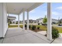 Inviting front porch with white columns and view of the street at 292 Shadybrook Dr, Summerville, SC 29486