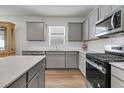 Modern kitchen with stainless steel appliances, ample counter space and grey cabinetry at 292 Shadybrook Dr, Summerville, SC 29486