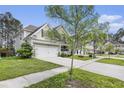 Attractive two-story home with a two-car garage, lovely landscaping, and a charming front porch at 317 Whispering Breeze Ln, Summerville, SC 29486
