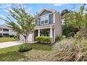 This two-story home boasts charming architectural details and manicured landscaping at 3321 Tabard Rd, Johns Island, SC 29455