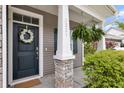 A welcoming entryway with a decorative wreath and hanging fern at 3321 Tabard Rd, Johns Island, SC 29455