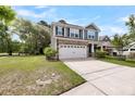 Two-story home with stone accents, a two-car garage, and a well-maintained front lawn at 3321 Tabard Rd, Johns Island, SC 29455
