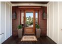 Elegant front entrance featuring a wood door, stylish sconces, and a welcoming mat at 337 Evian Way, Mount Pleasant, SC 29464